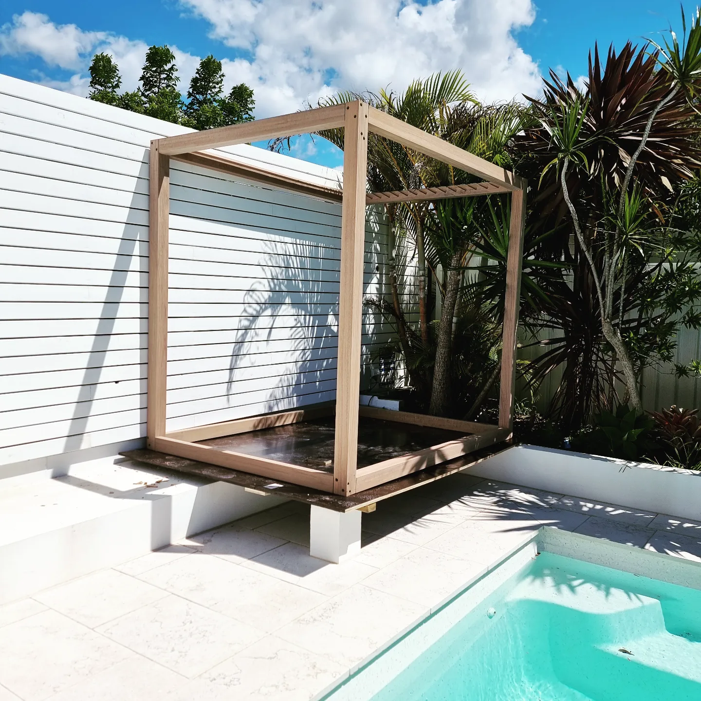 Timber cabana frame beside pool
