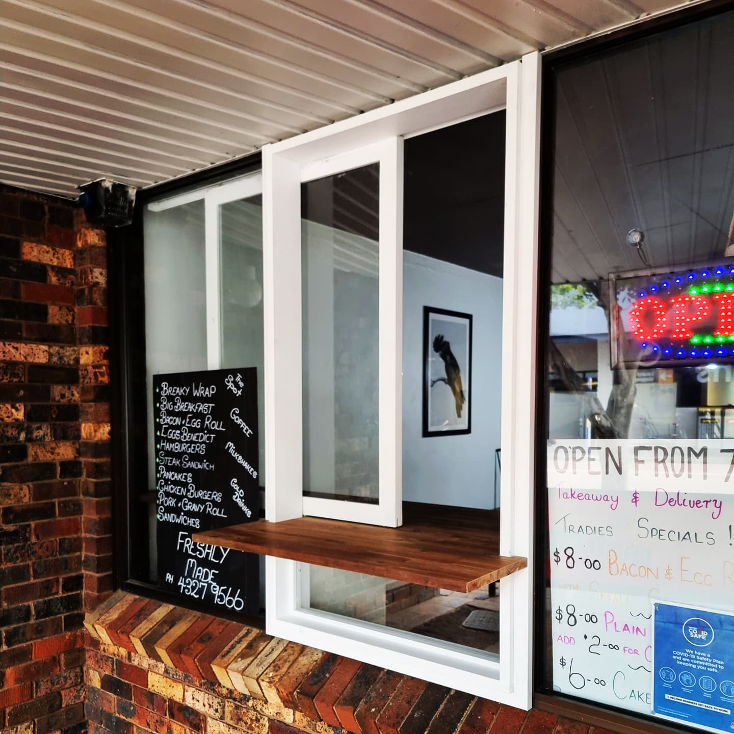 Custom cafe servery window with timber bench
