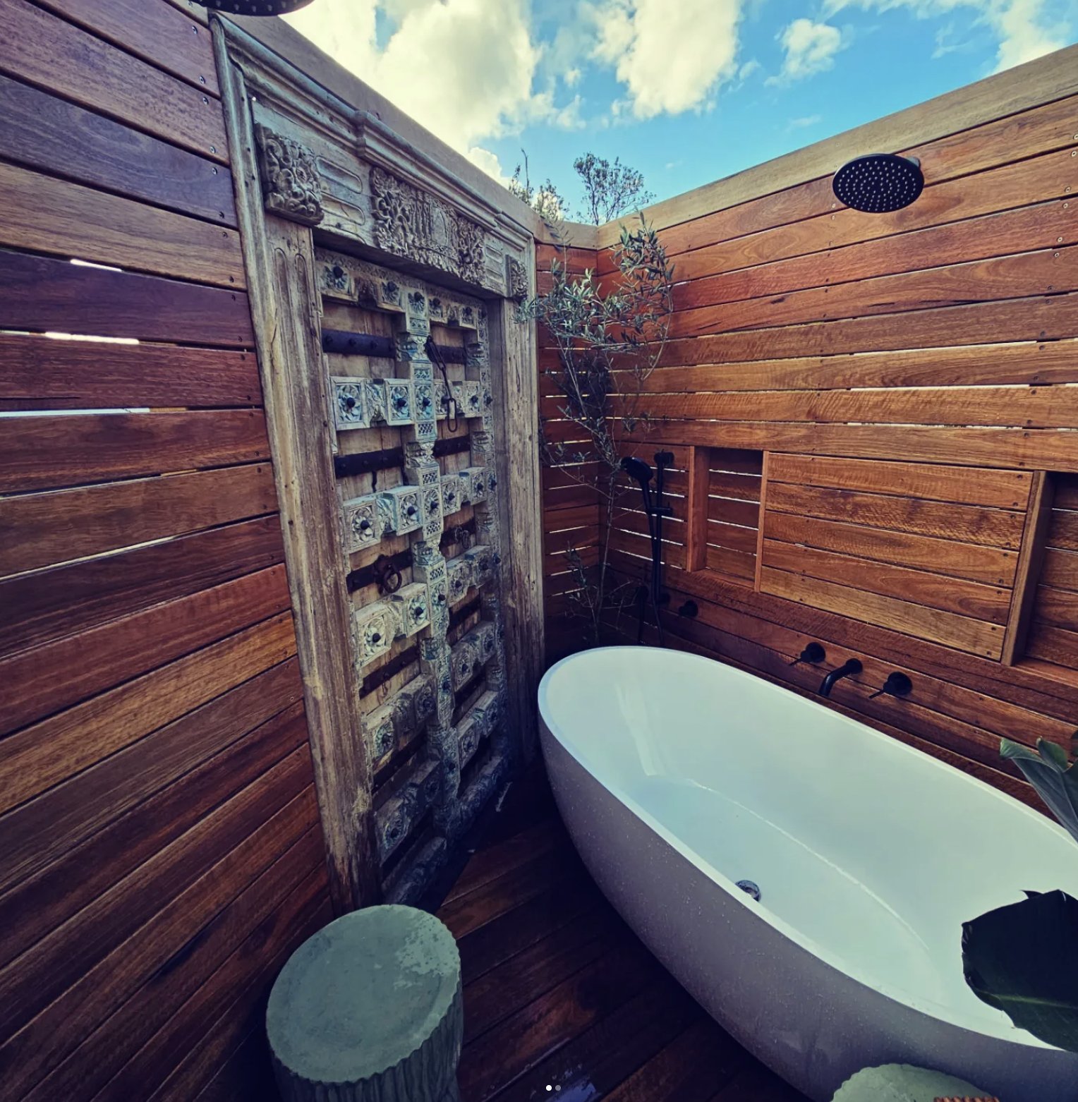 Luxury tropical outdoor bathroom in North Avoca with hardwood cladding and Indian timber door