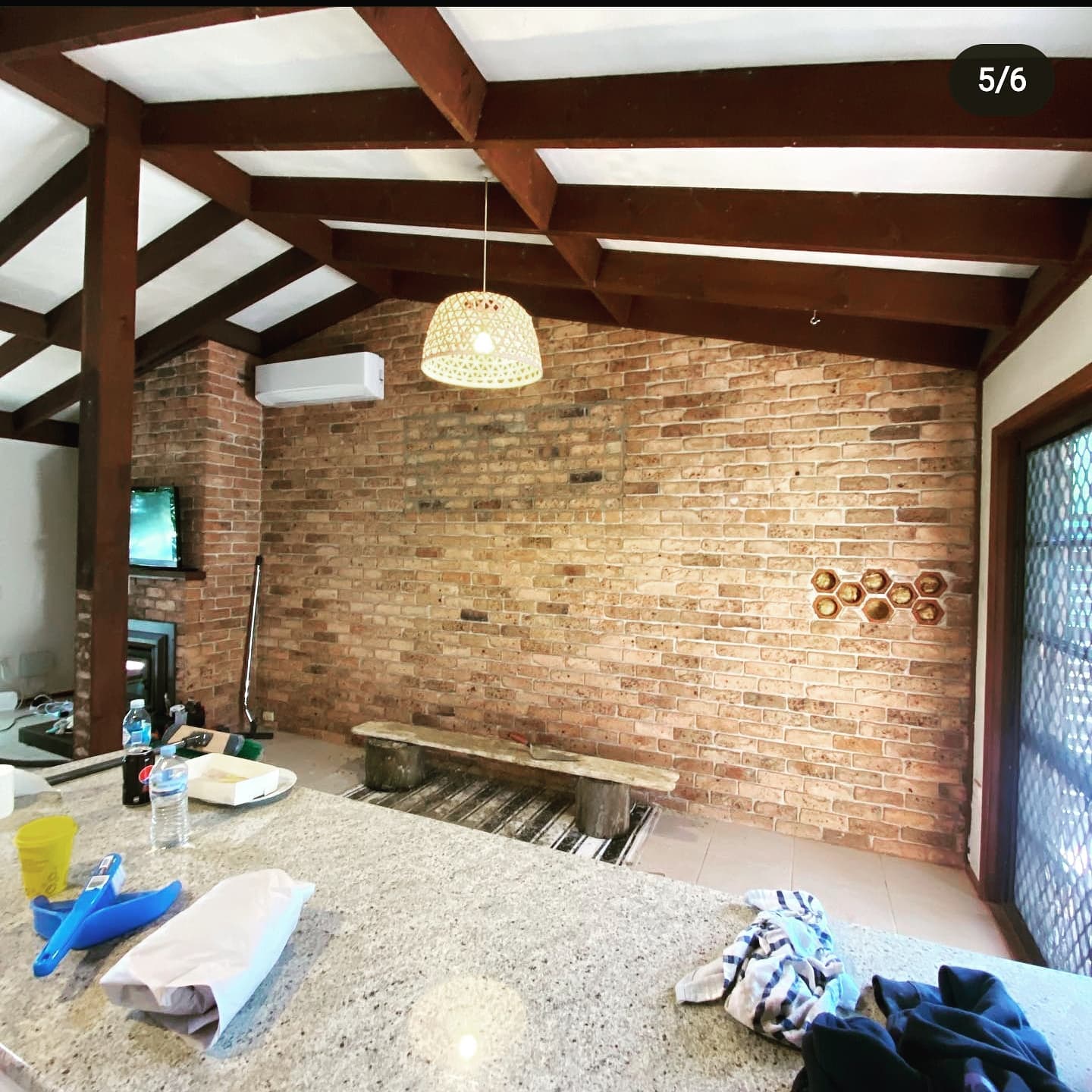 Interior with feature brick wall and exposed timber rafters