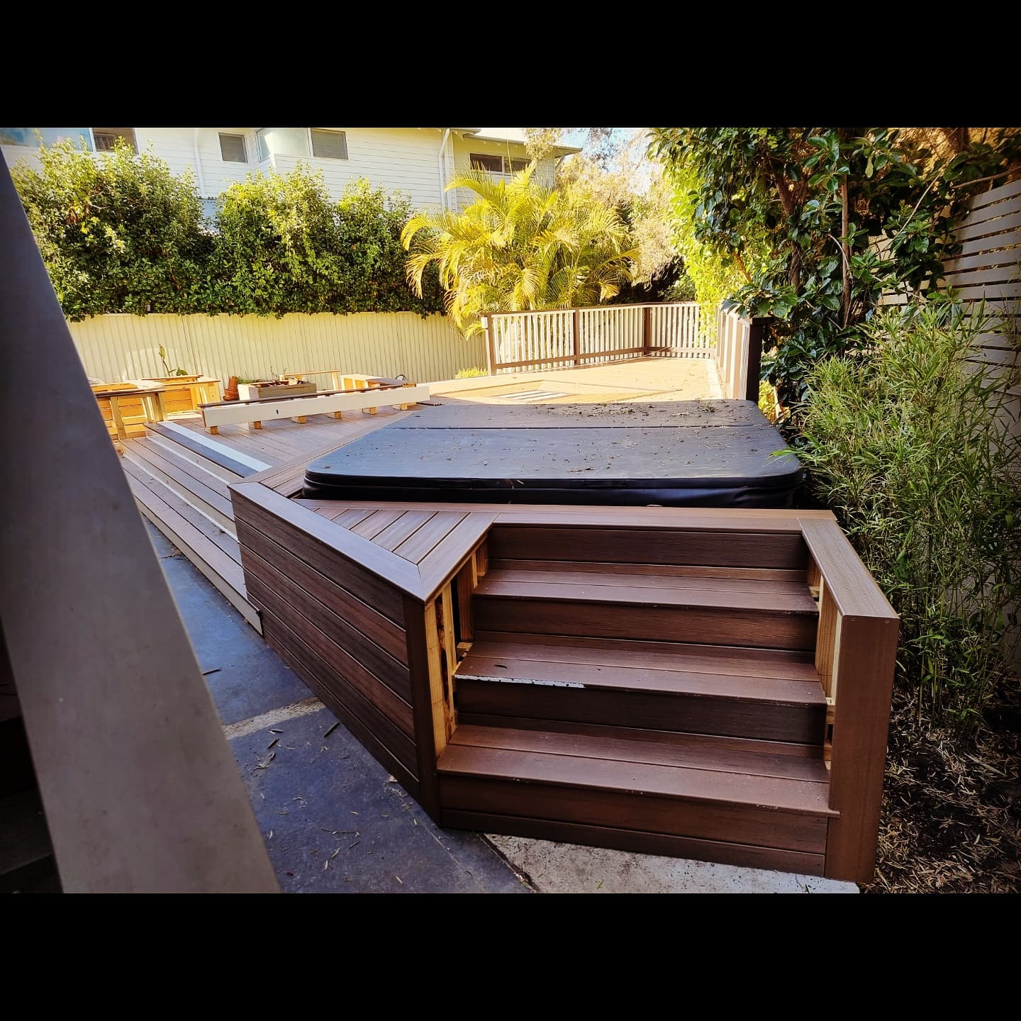 Composite timber spa deck with steps and hot tub