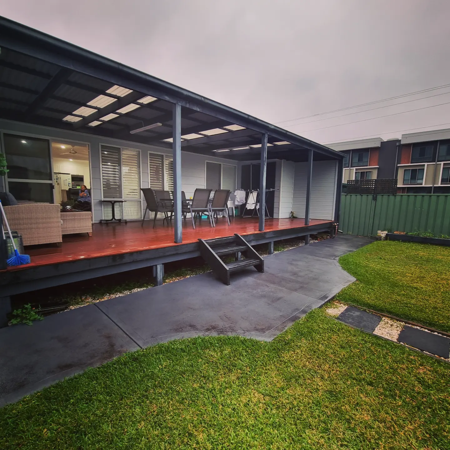 Covered timber deck with steel posts and outdoor lounge
